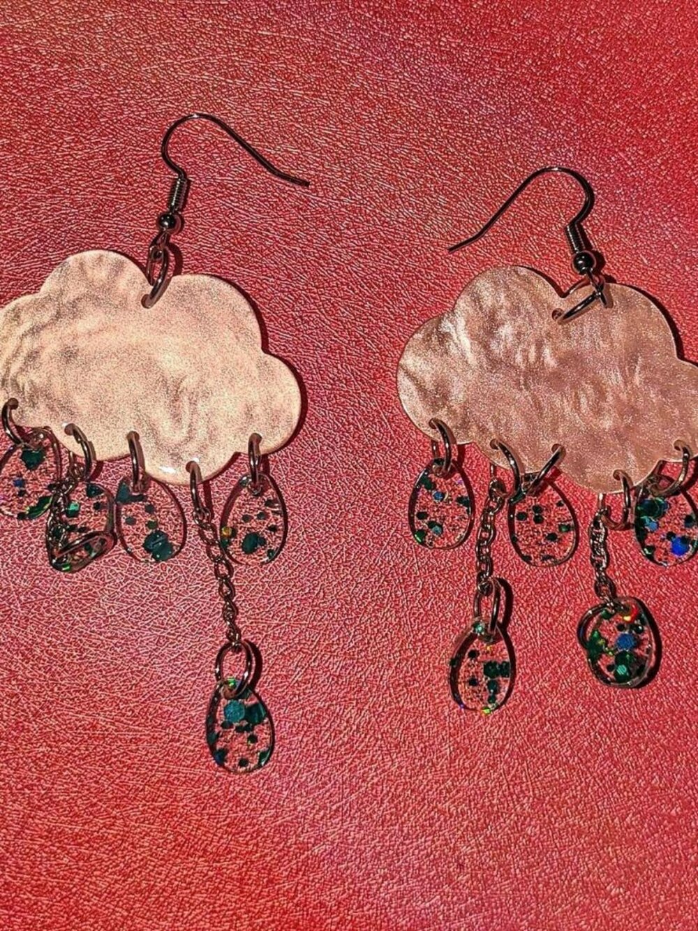 Cloud earrings with dangling teardrop charms featuring glittery details